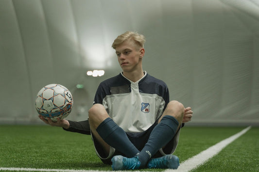 Beginner five-a-side guide featuring a player with a soccer ball in an indoor facility