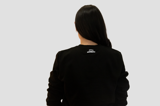 Back view of a woman wearing a black sweatshirt representing the Bodydisciple fitness journey