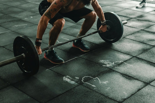 Man performing a deadlift in a gym setting to beat gym intimidation and build strength