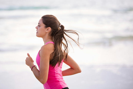 Beginner running guide with a girl jogging on the beach, enjoying the fresh air and exercise