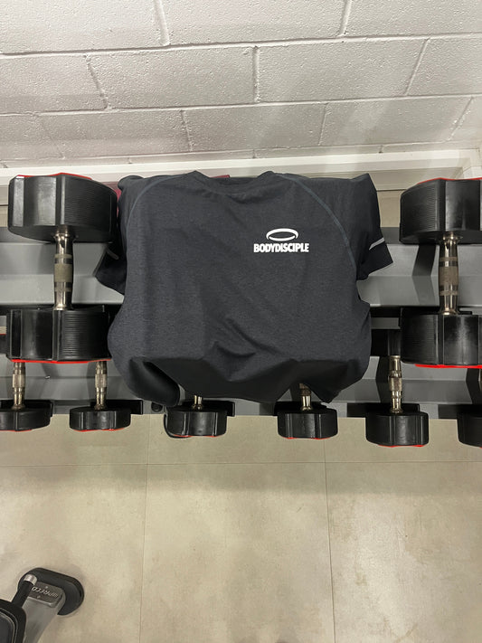 Scottish sportswear evolution illustrated with a workout shirt on a gym bench beside dumbbells
