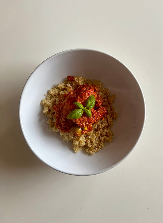 Spicy Tuna Bowl Recipe with quinoa, rich tomato-chilli sauce, and fresh basil garnish