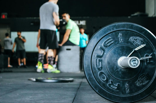 Weightlifting equipment in a gym setting illustrating tips on how to stay motivated at the gym