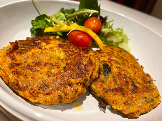 Delicious Sweet Potato Salmon Cakes Recipe served with fresh salad and cherry tomatoes