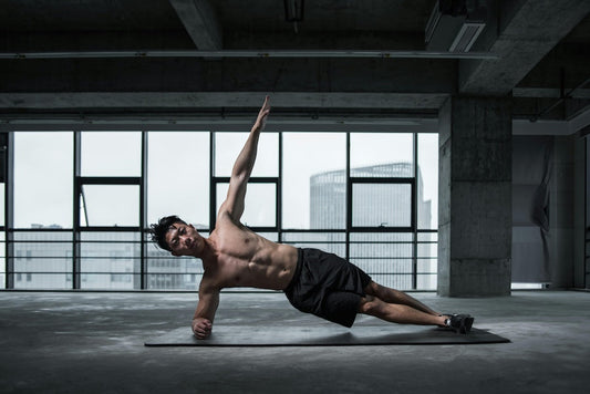 Man performing a side plank exercise in a modern gym for a beginner supplements guide