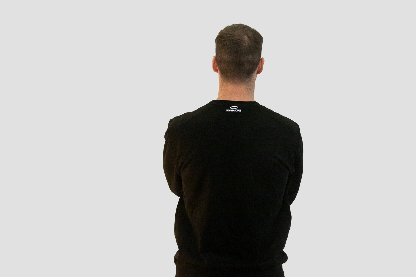 Men's black sweatshirt from BodyDisciple featuring a minimalist design and comfortable fit