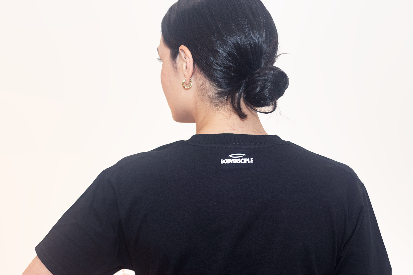 Back view of Women's Black Halo Tee by BodyDisciple, showcasing a simple design and comfortable fit