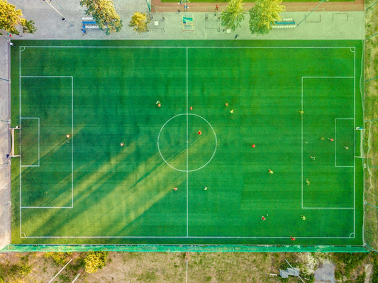 An aerial shot of a football pitch, showing people enjoying a game of walking football.