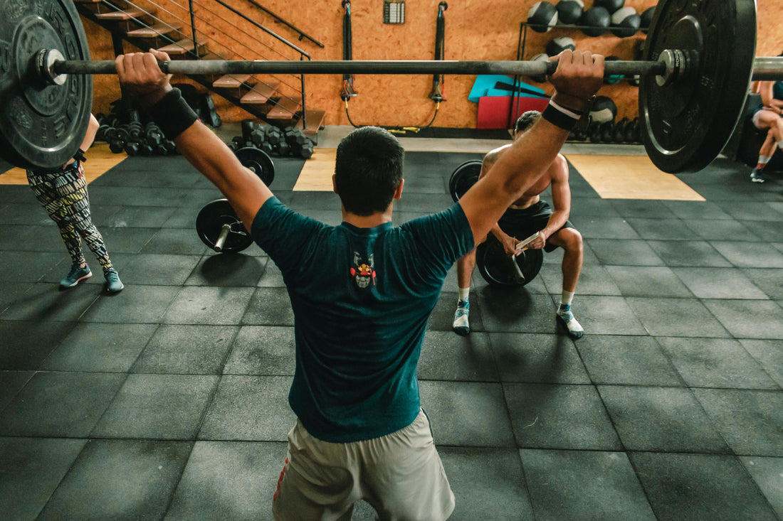 Person lifting weights at the gym, showcasing motivation for gym workouts and training sessions