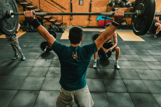 Person lifting weights at the gym, showcasing motivation for gym workouts and training sessions