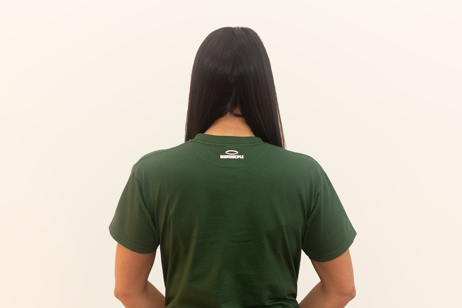 A woman, looking away, wearing Bodydisciple green tee B24D301GRN_Womens_3