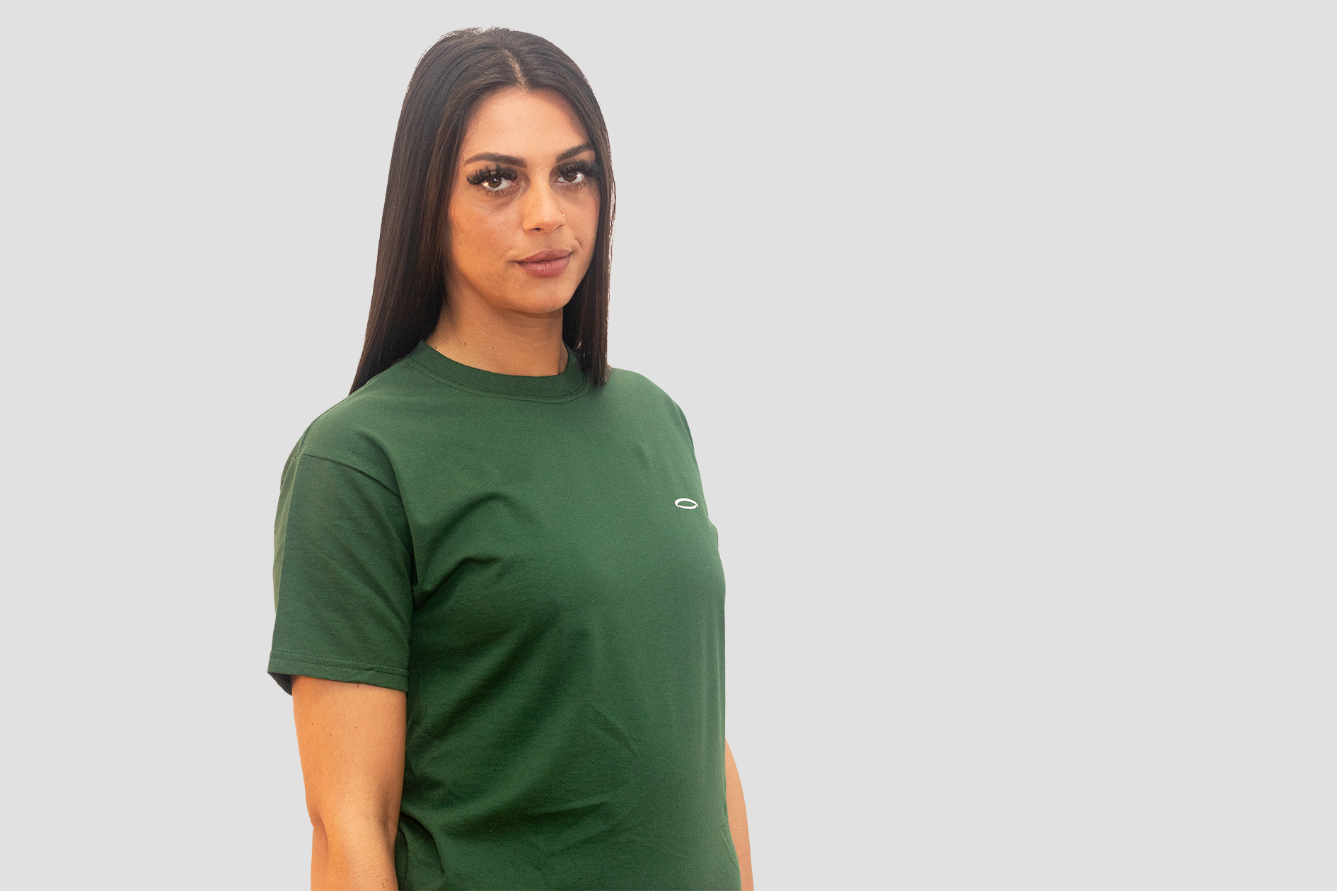 A woman, smiling, wearing Bodydisciple green tee B24D301GRN_Womens_4