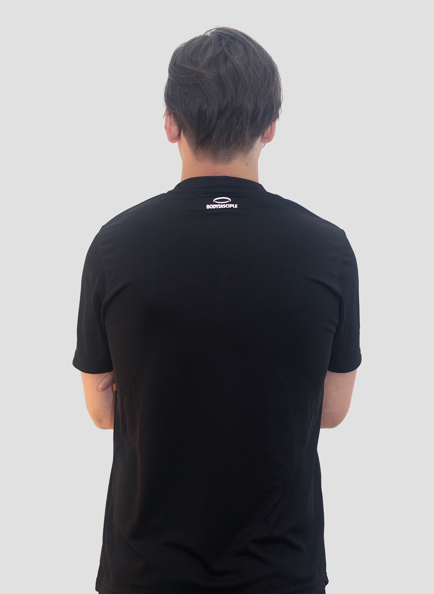 A man looking away wearing Bodydisciple Black Tee B24D302BLK_Men_3