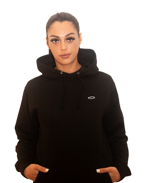 A woman, looking at camera, wearing Bodydisciple black hoodie B24D501BLK_Women_1