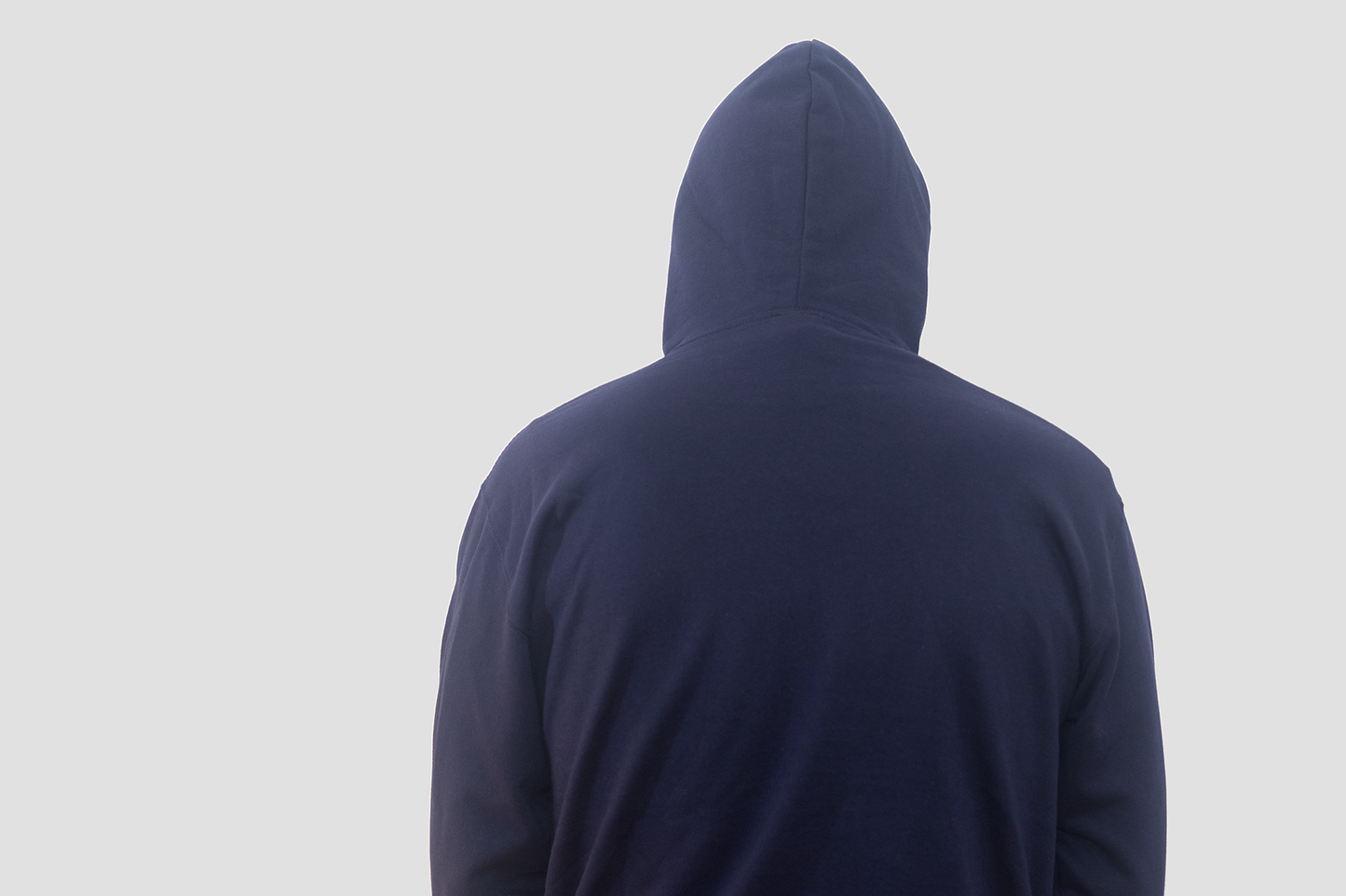 A man, facing away, wearing a Bodydisciple navy hoodie B24D512BLU_Men_1