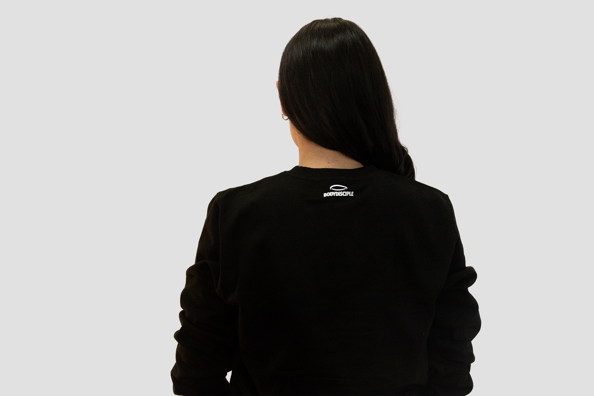 Back view of women's black sweatshirt by BodyDisciple featuring a casual design and comfortable fit