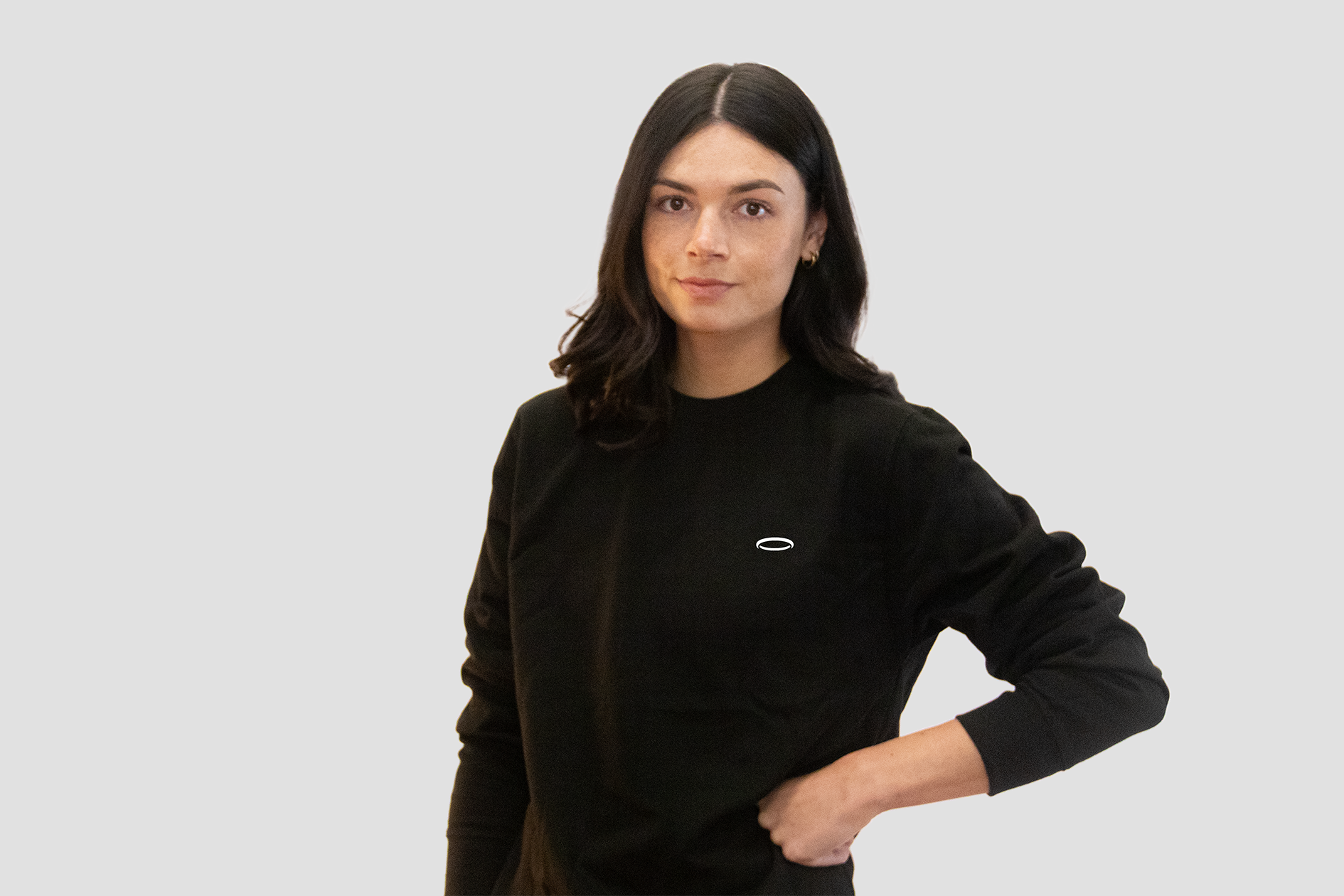 Model wearing a women's black sweatshirt from BodyDisciple with a minimalistic design