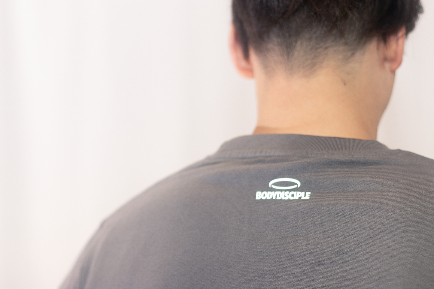 Men's Stone Sweatshirt by bodydisciple featuring a minimalist logo on the back for stylish comfort
