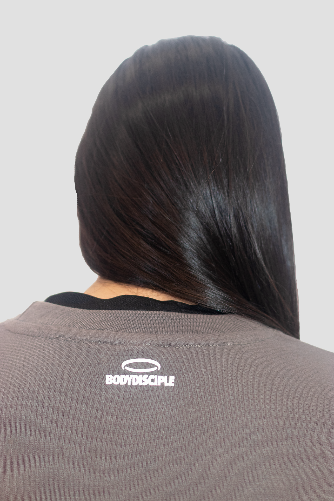 Back view of a Stone colored sweatshirt by Bodydisciple with logo detail