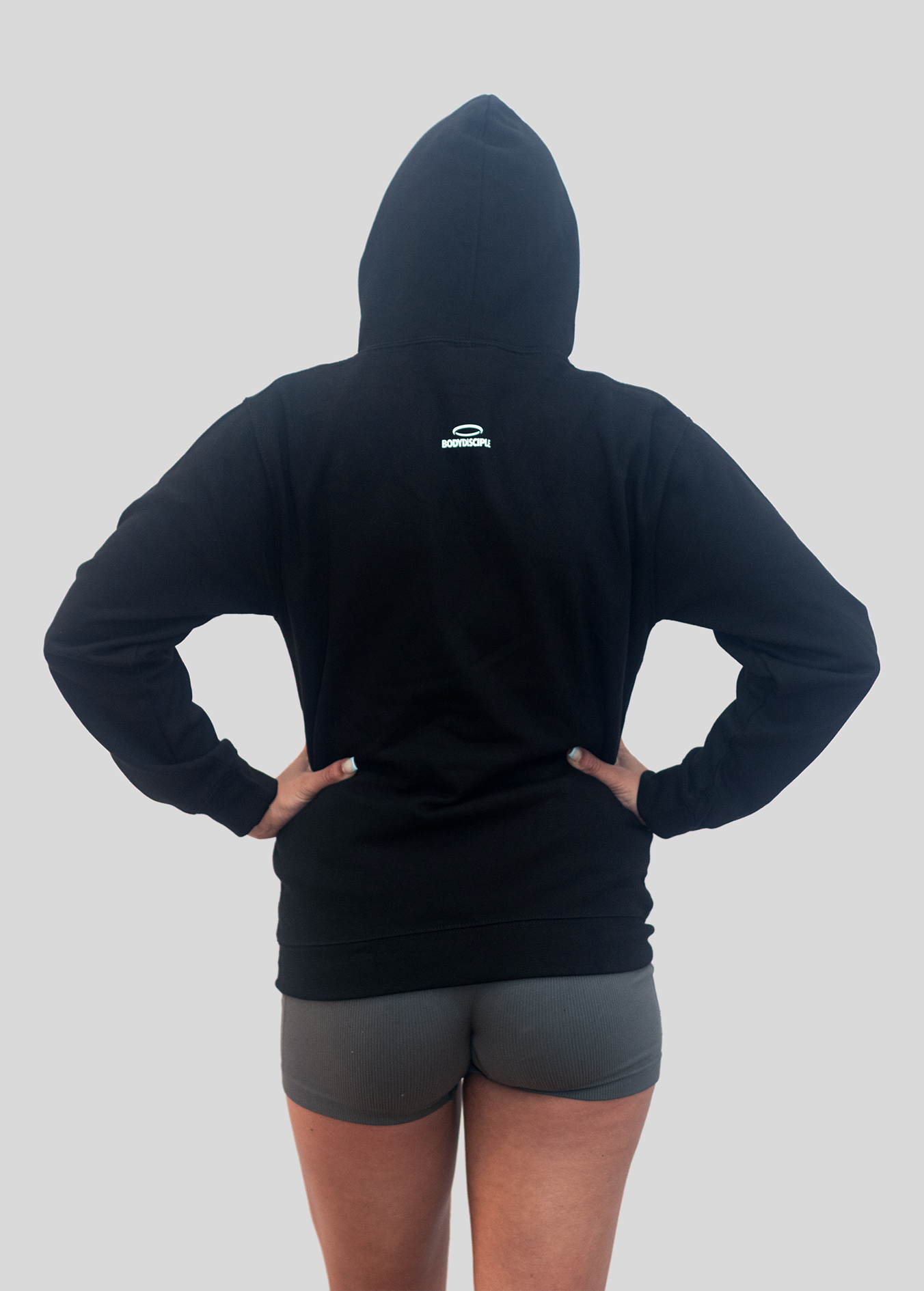 Back view of women's black hoodie sportswear from BodyDisciple designed for comfort and style